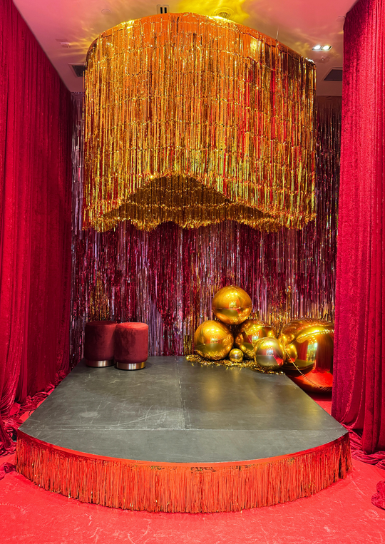Gold Fringe Chandelier Installation with gold Orbz