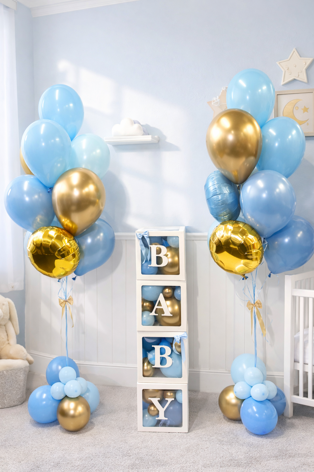 Decorative setup with blue and gold balloons and a 'BABY' sign in a room.