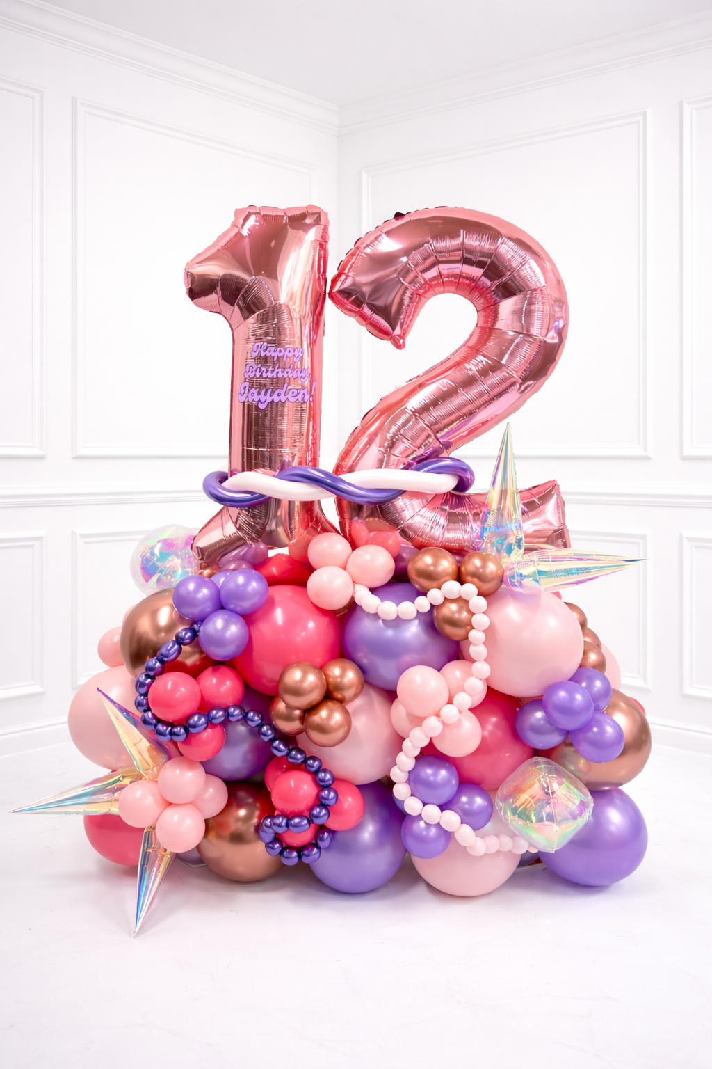 Colorful balloon arrangement with number '12' on a white background