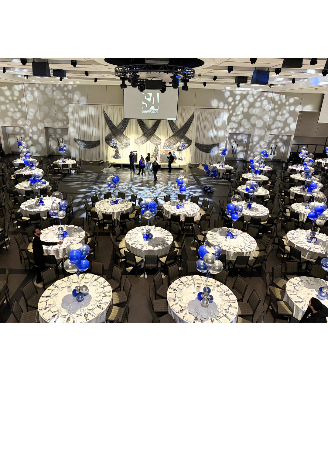 Custom table centrepieces with clear bobos and feathers