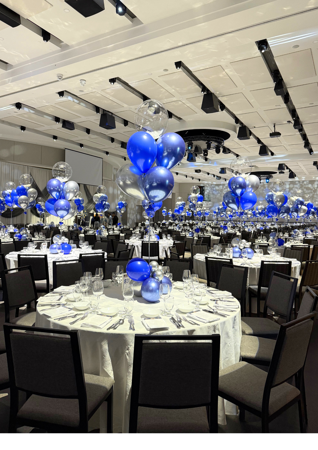 Custom table centrepieces with clear bobos and feathers