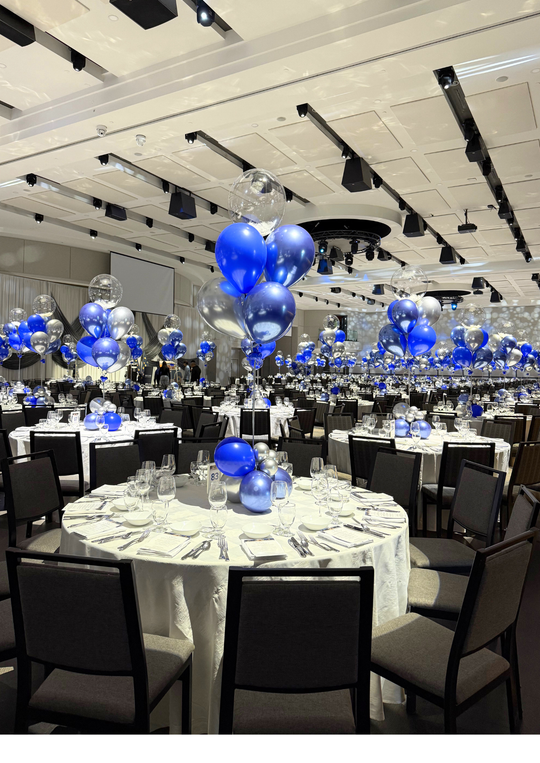 Custom table centrepieces with clear bobos and feathers
