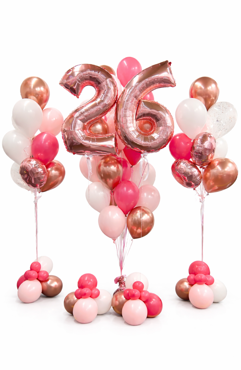 Balloon arrangement with a large '26' rose gold balloon on a white background