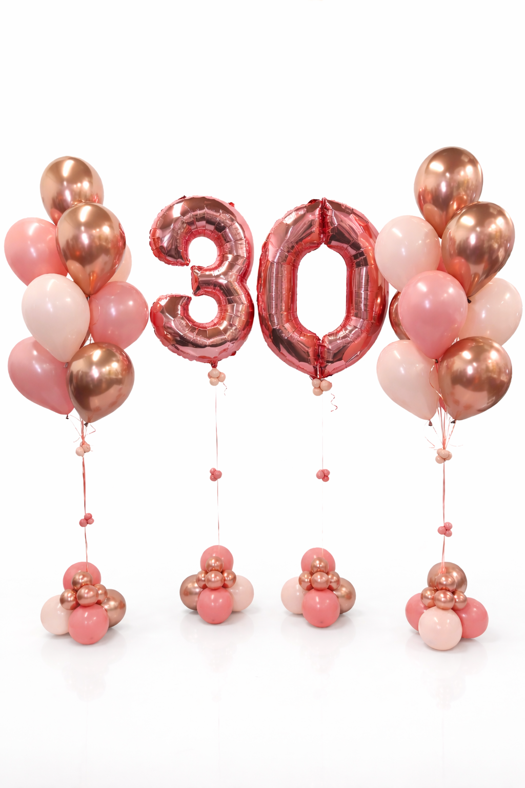 Pink and rose gold balloons with a '30' balloon on a white background