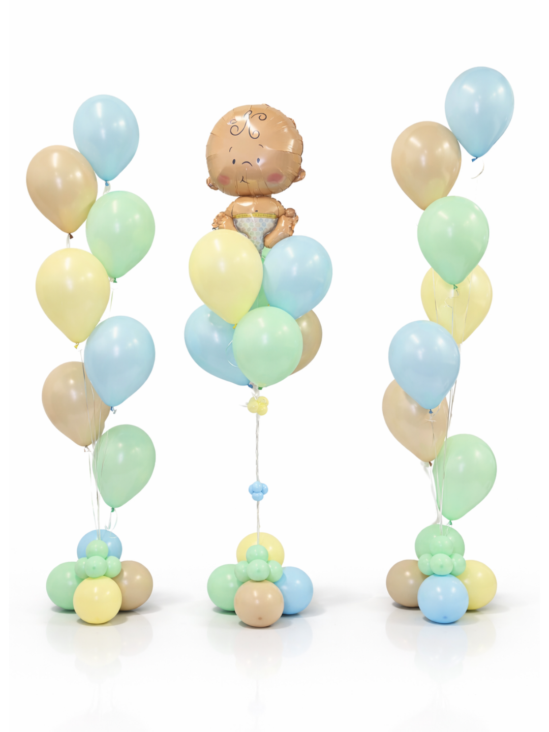 Pastel-colored balloon arch with a baby figurine on a white background