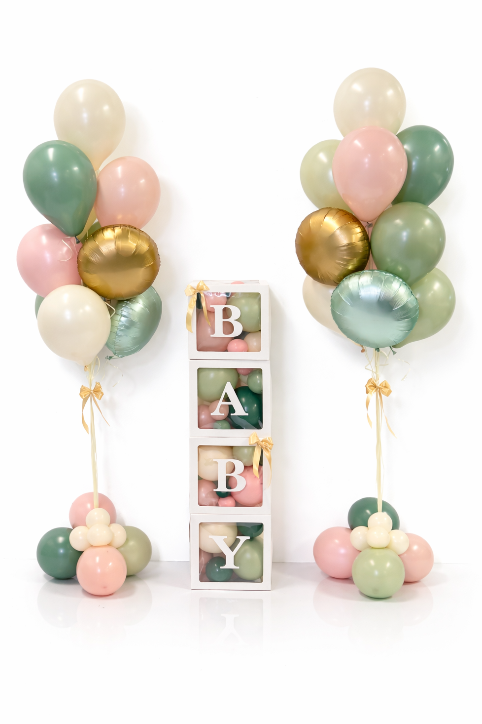 Pastel-colored balloons arranged in a decorative setup with a 'BABY' sign.