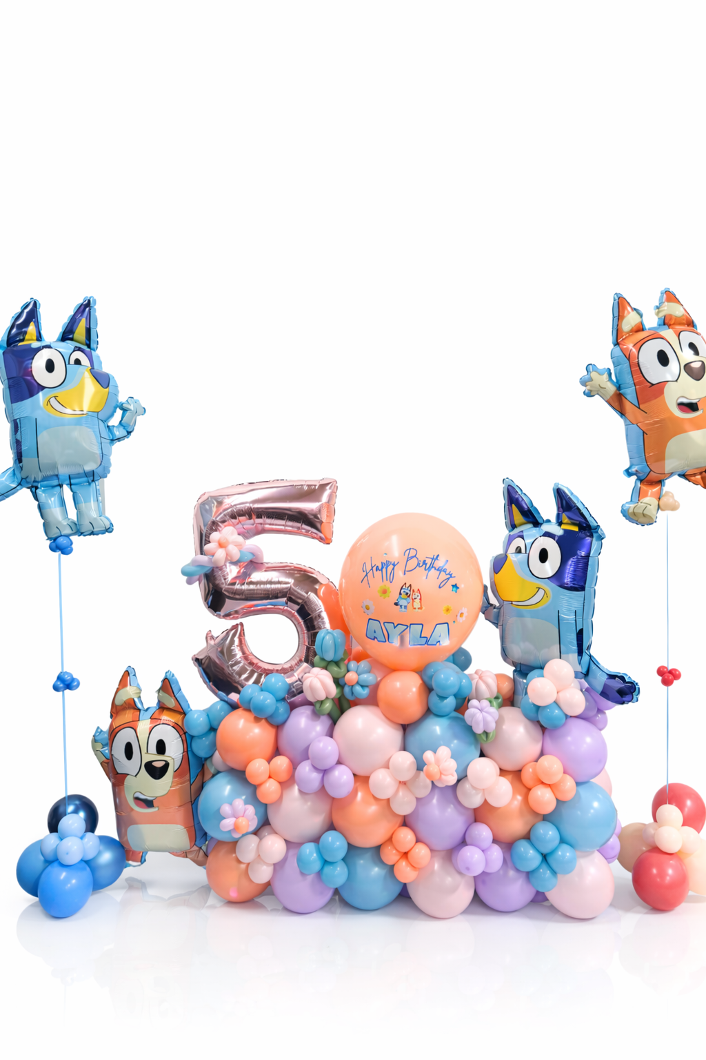 Colorful balloon arrangement with cartoon character balloons and number '5' on a white background