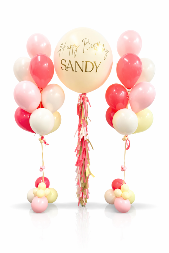 Decorative balloon bouquet with 'Happy Birthday Sandy' on a white background