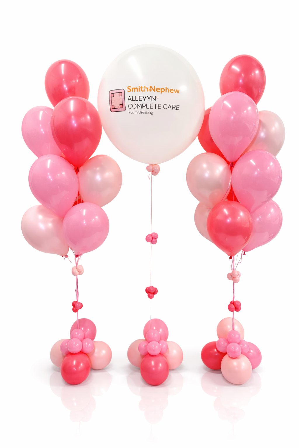 Pink and white balloons with a Smith & Nephew balloon featuring the brand logo on a white background.
