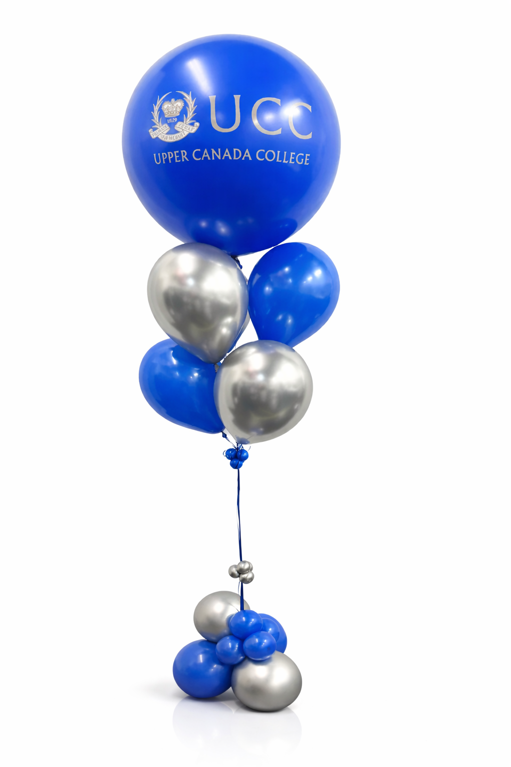 Set of blue and silver balloons with Upper Canada College logo on a white background