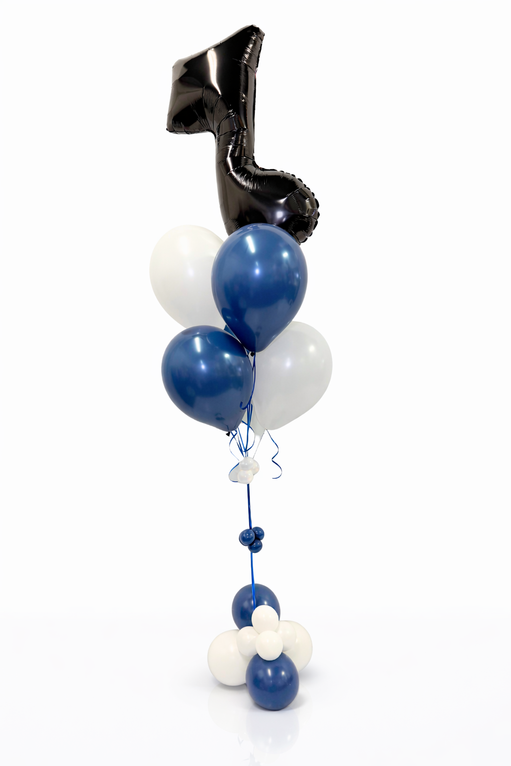 Balloon arrangement with blue, white, and black balloons on a white background