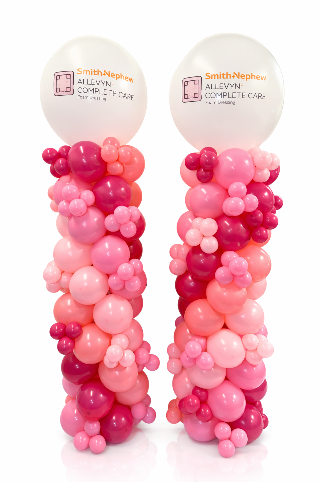 Two balloons with Smith-Nephew Alleyn Complete Care branding, wrapped in pink and red balloons on a white background.