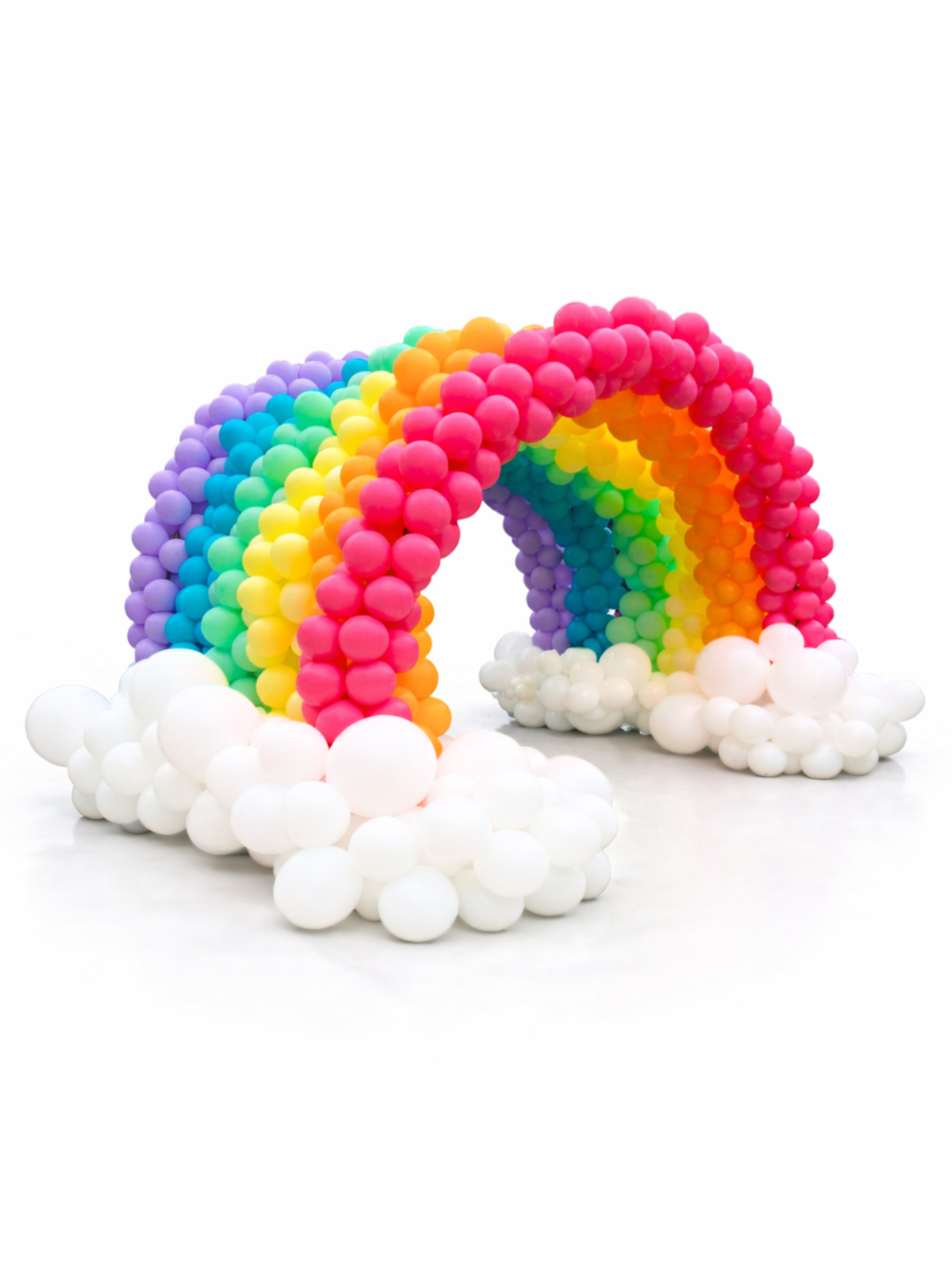 Colorful balloon arch shaped like a rainbow with white balloons on a white background