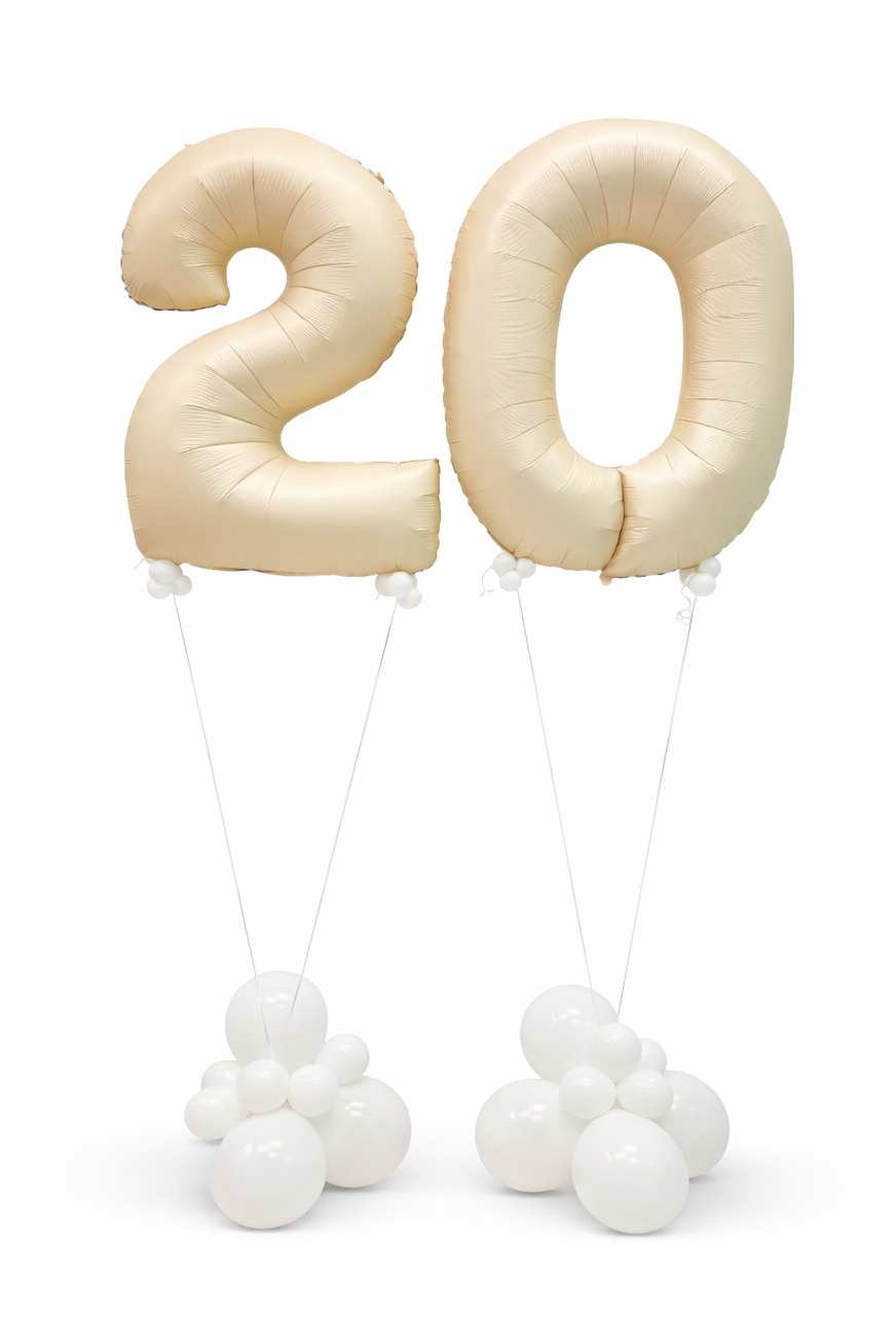 Beige number '20' balloons with white strings on a white background